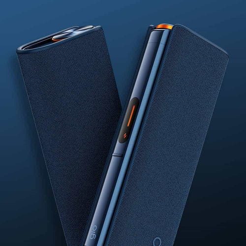 Two sleek, dark blue electronic devices with textured surfaces are shown standing upright against a matching blue background. One device displays an orange button and metallic accents, suggesting a modern, stylish design.