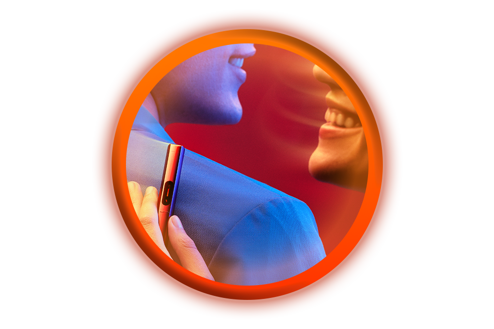 A close-up of two people smiling at each other, one holding a slim electronic device against the others shoulder, with a vibrant red and blue background and an orange circular border.