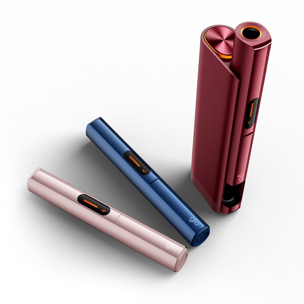 Three sleek, modern electronic devices in pink, blue, and red are displayed on a light surface. The red device is standing upright and open, while the pink and blue devices are lying flat and closed.