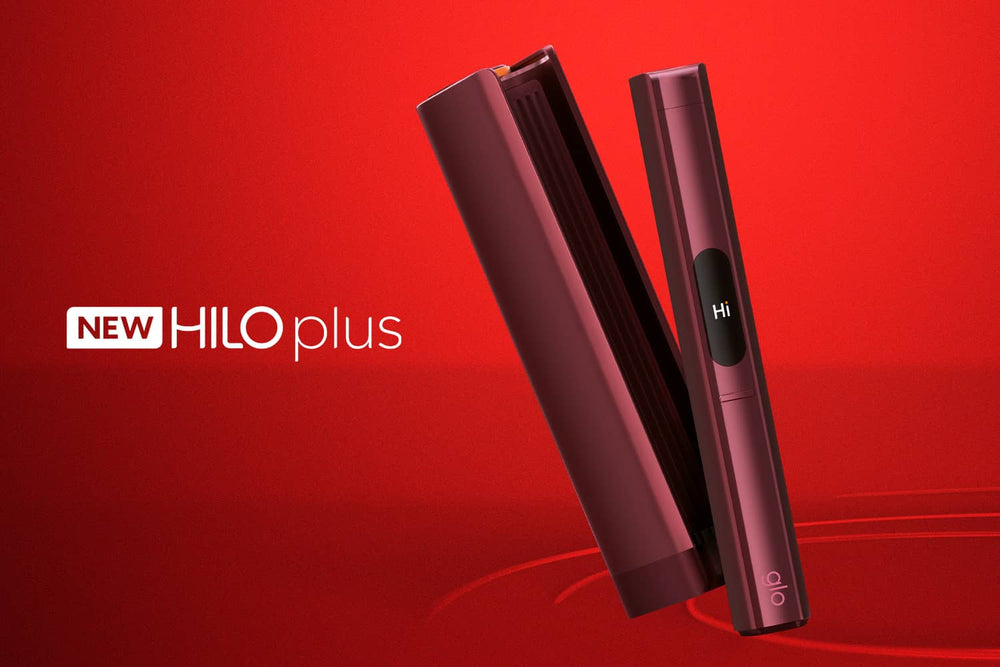 Sleek red electronic device labeled Hi on screen, with its case beside it, displayed on a vibrant red background. Text reads NEW HILO plus.