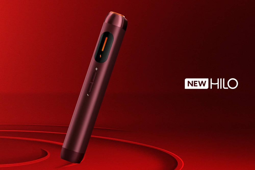 A sleek, red electronic device stands upright on a matching red background. The word NEW HILO is displayed in bold white text to the right of the device.