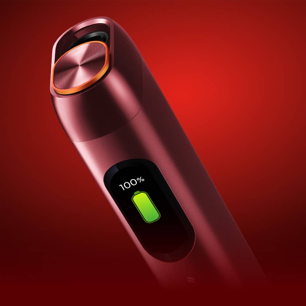 A sleek, red electronic device with a digital screen displaying a 100% battery charge on a glowing red background.