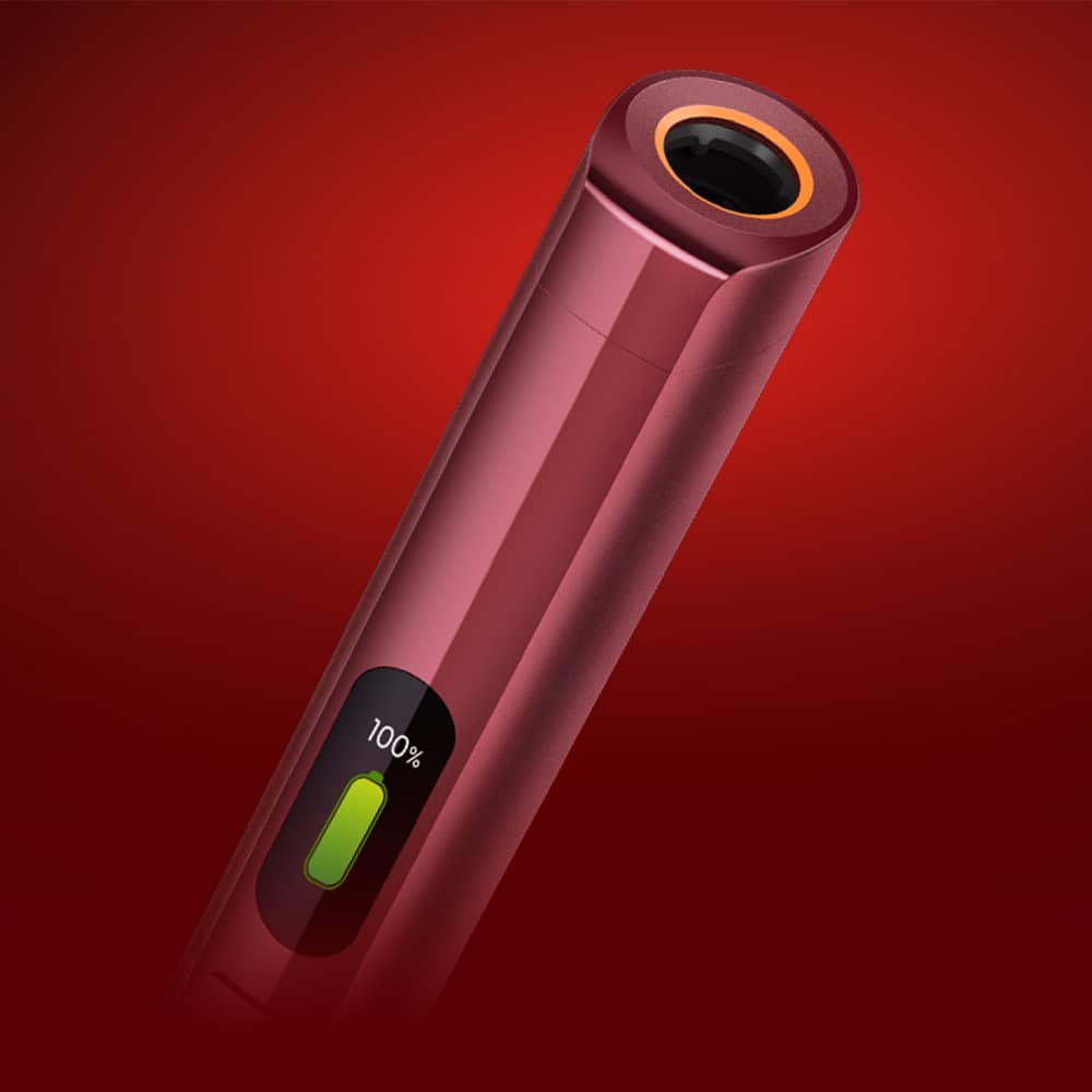 A close-up of a sleek, red cylindrical electronic device with a small display showing 100% and a green battery icon, set against a red gradient background.