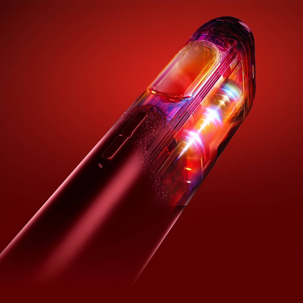 Close-up of a sleek, red electronic device with a transparent section revealing glowing, colorful internal components, set against a vibrant red background.
