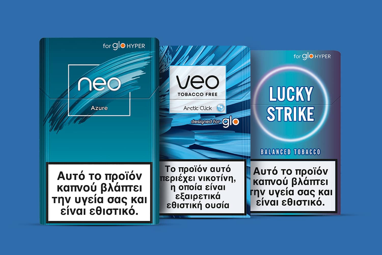 Three cigarette packs (Neo, VEO, and Lucky Strike) with Greek health warnings, set against a light blue background. Each warning states that smoking damages your health and is addictive.