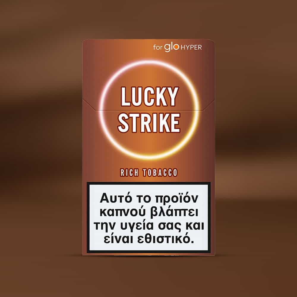 Lucky Strike Rich Tobacco for glo HYPER is shown on a brown background. The Greek warning label states smoking harms health and is addictive. This high-intensity blend features Burley notes and bright tobacco.