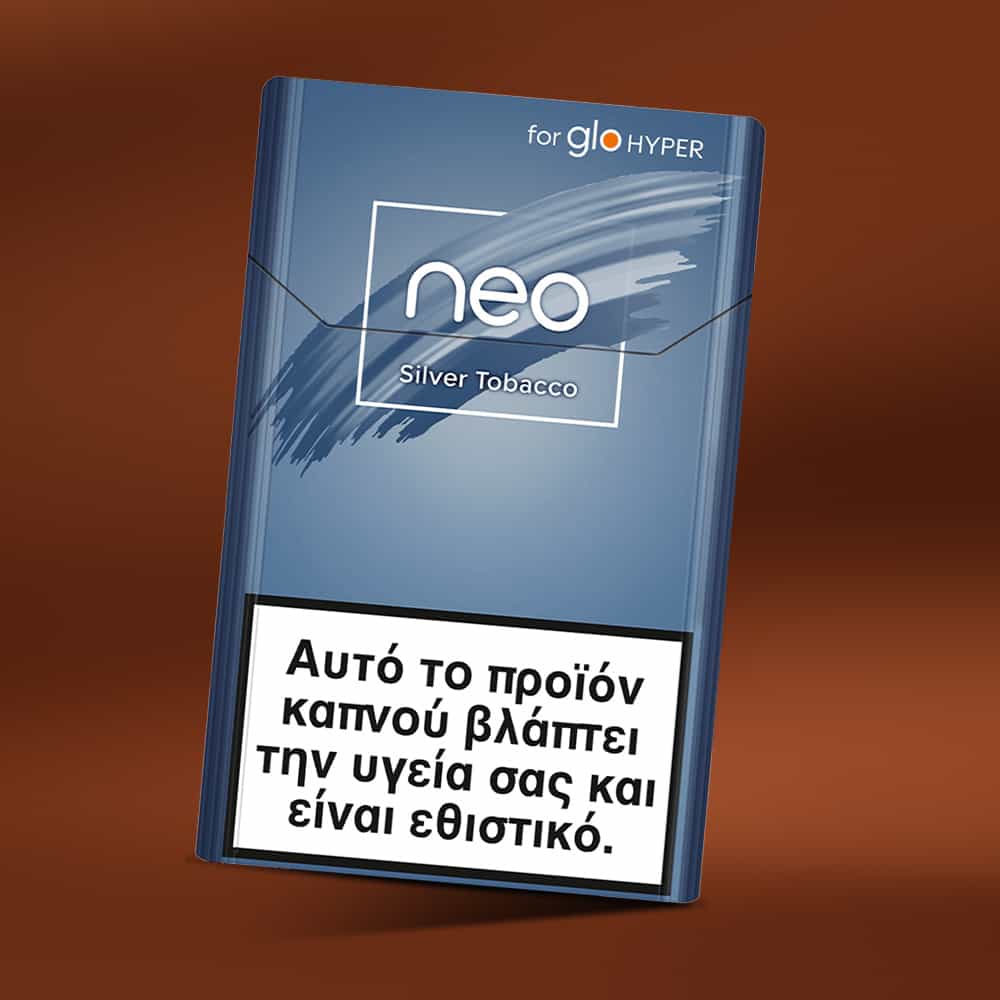 A pack of neo™ Silver Tobacco for glo HYPER stands upright on a brown background. At the bottom, there's a Greek health warning stating this product is harmful to health and addictive.