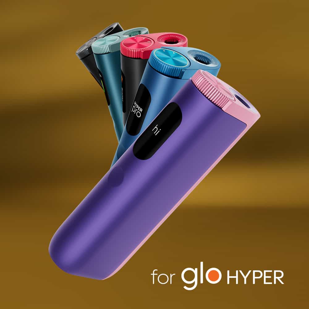 A group of colorful Lucky Strike Gold Tobacco vaping devices stands upright on a brown gradient background, evoking creamy notes and coffee caramel flavor, with the text for Lucky Strike Gold Tobacco in the lower right corner.