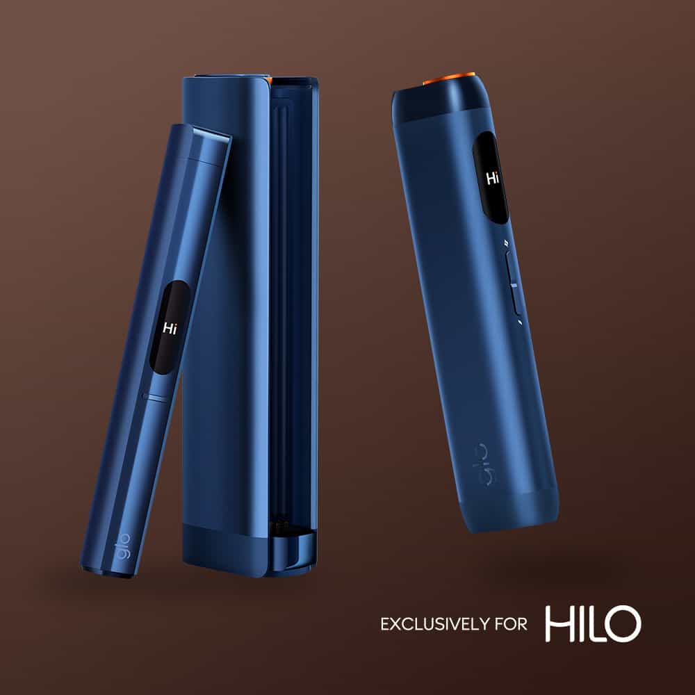 Sleek, dark blue virto™ Signature Tobacco devices displayed on a brown background. One stands upright, another rests in its matching rectangular case. Text reads EXCLUSIVELY FOR HILO.