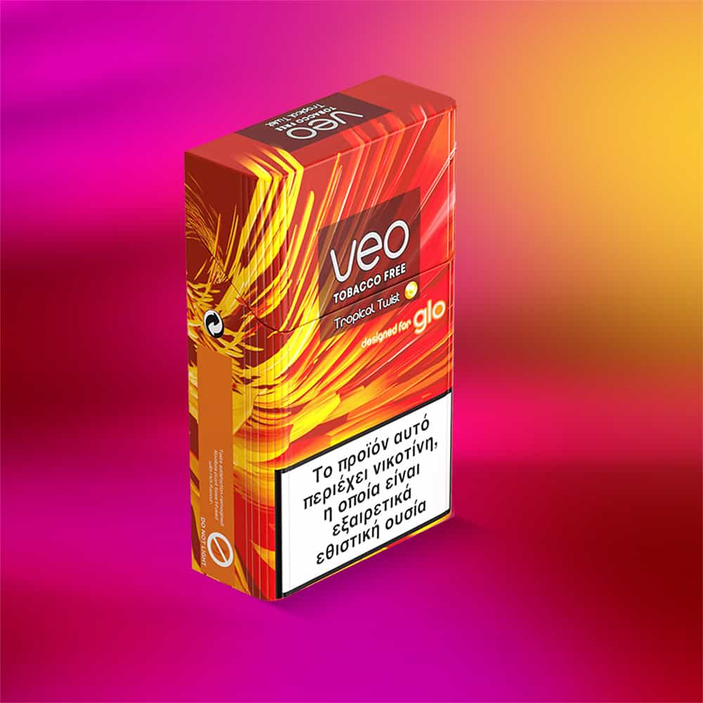 A colorful box of veo™ Tropical Twist for Glo is displayed on a vibrant pink-orange gradient background, featuring a Greek health warning label on its front.