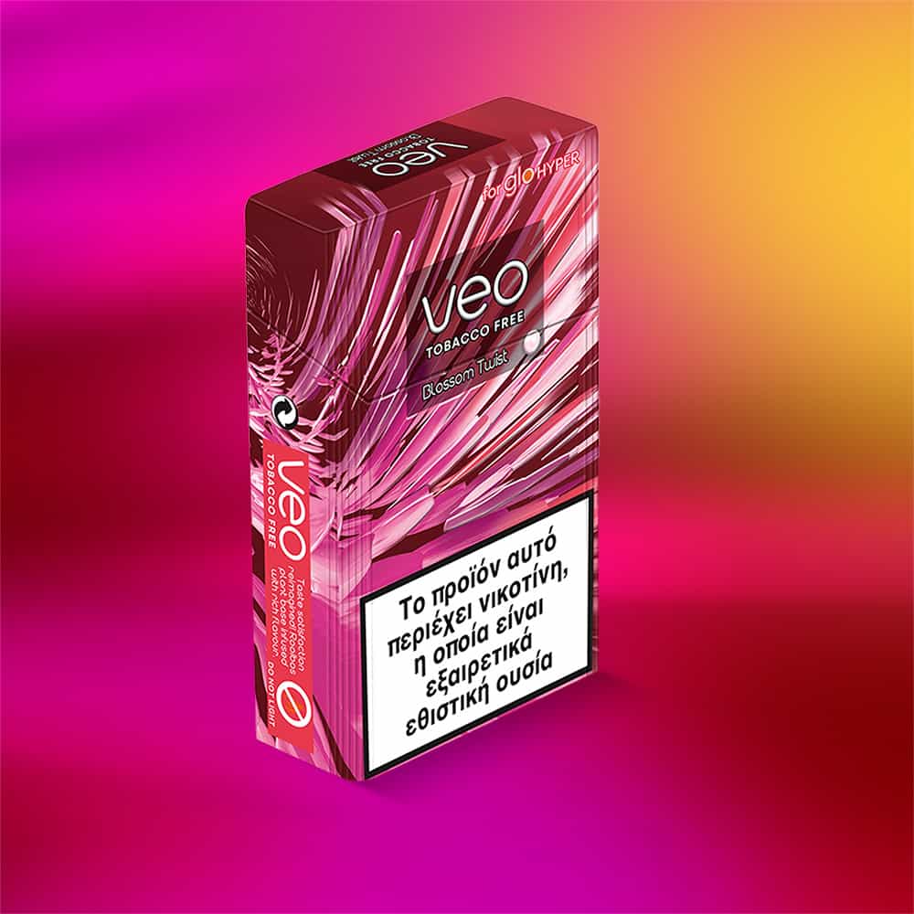A pink and red box of veo™ Blossom Twist tobacco-free sticks sits on a matching gradient background. The box features white abstract patterns and Greek text warning about nicotine on the front.