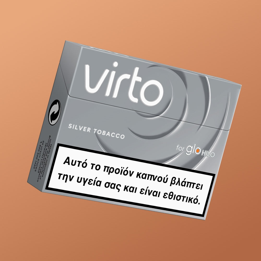 A silver pack of virto™ Silver Tobacco for glo™ h e h i o is shown against a light brown background, with a Greek health warning label on the front.
