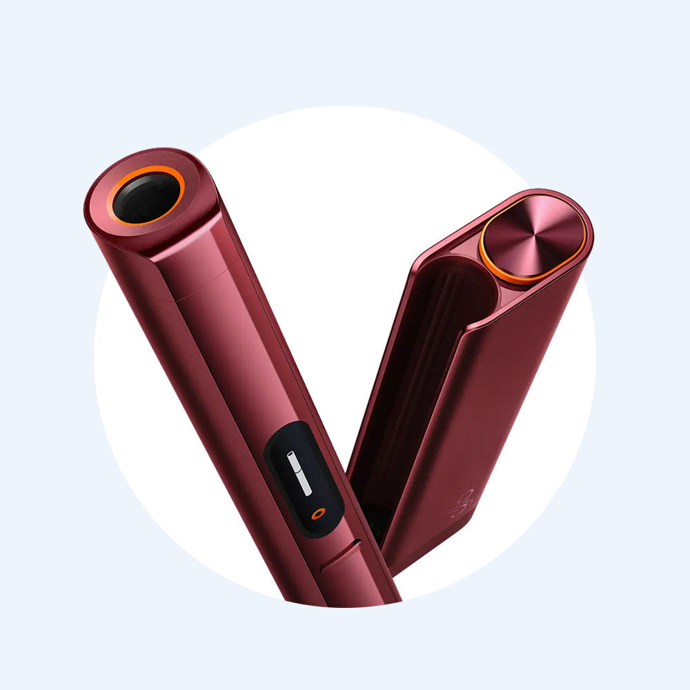 A sleek, metallic red electronic device with two hinged parts, one featuring a circular black and orange opening and the other with a button and small display, set against a light background.