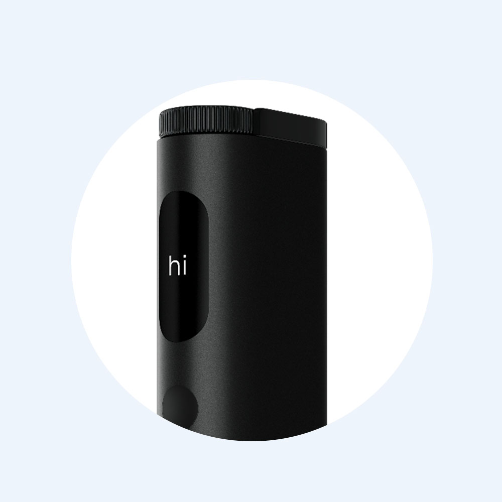 A sleek black cylindrical device with a digital display showing the word hi. The device has a textured top and a smooth body, set against a light blue circular background.