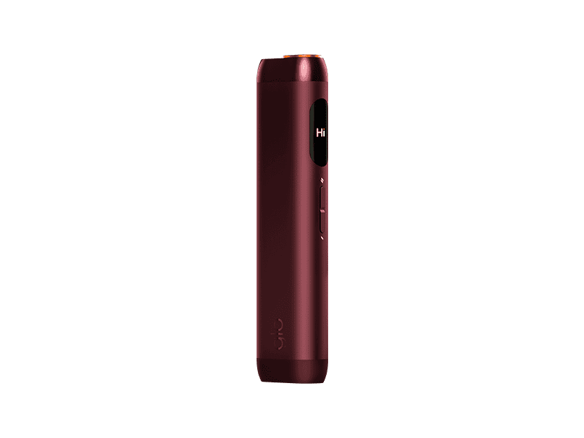 A sleek, metallic red glo™ HILO device stands upright against a plain light gray background. This advanced vaping device features a small side display screen and buttons.