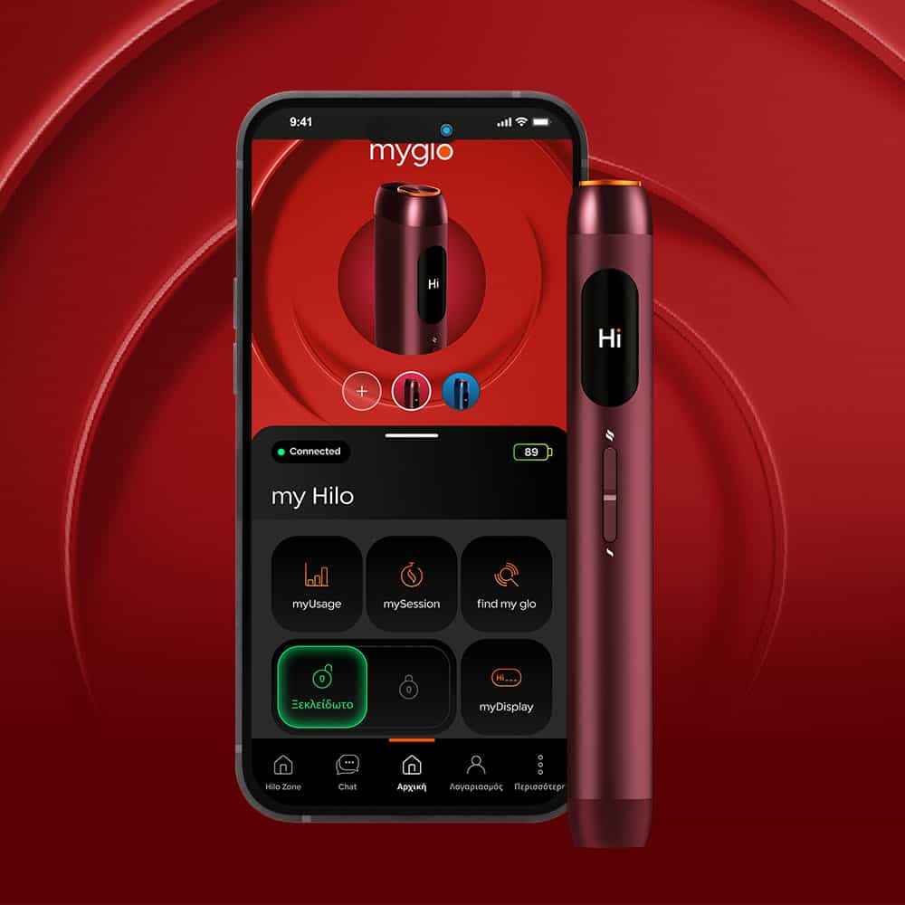 A smartphone displaying an app interface with a red electronic device shown both on the phone screen and standing next to it, against a red textured background. The device has a small screen displaying Hi.