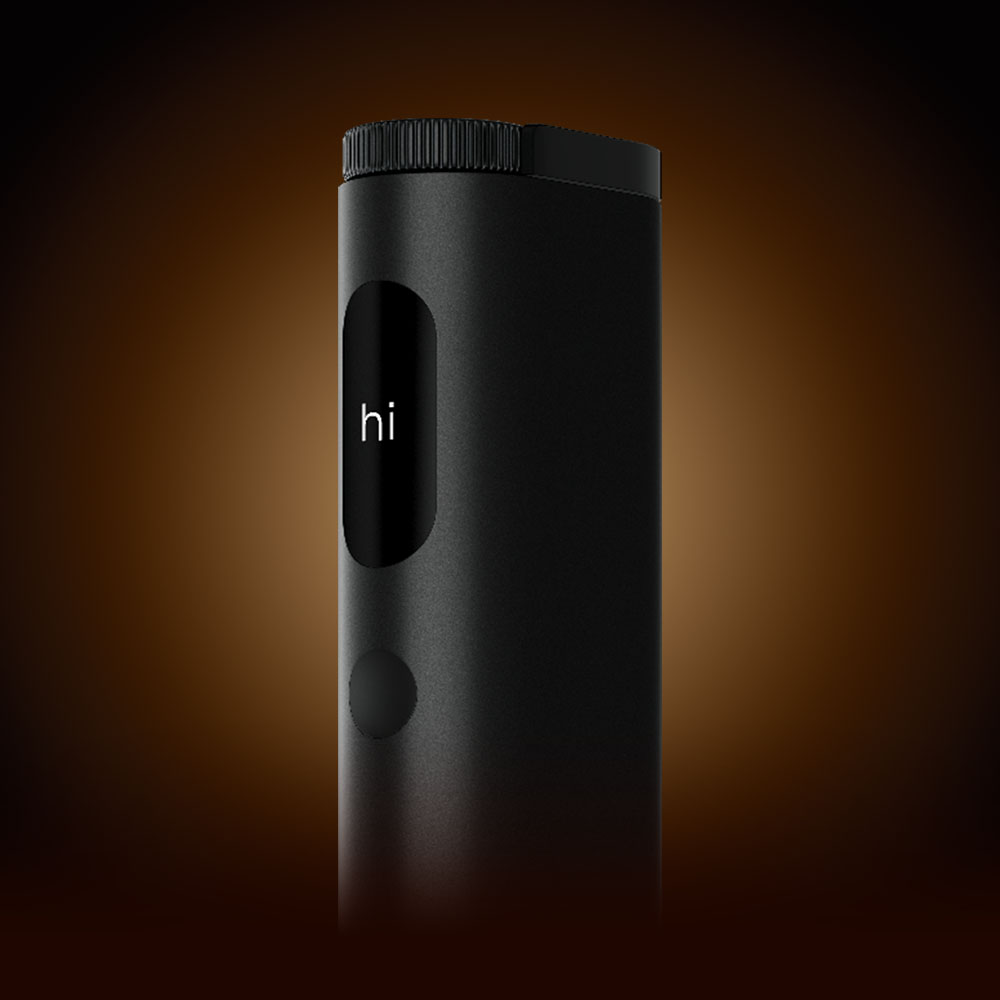 A sleek black electronic device with a small screen displaying the word hi and a circular button below it, shown against a dark gradient background.