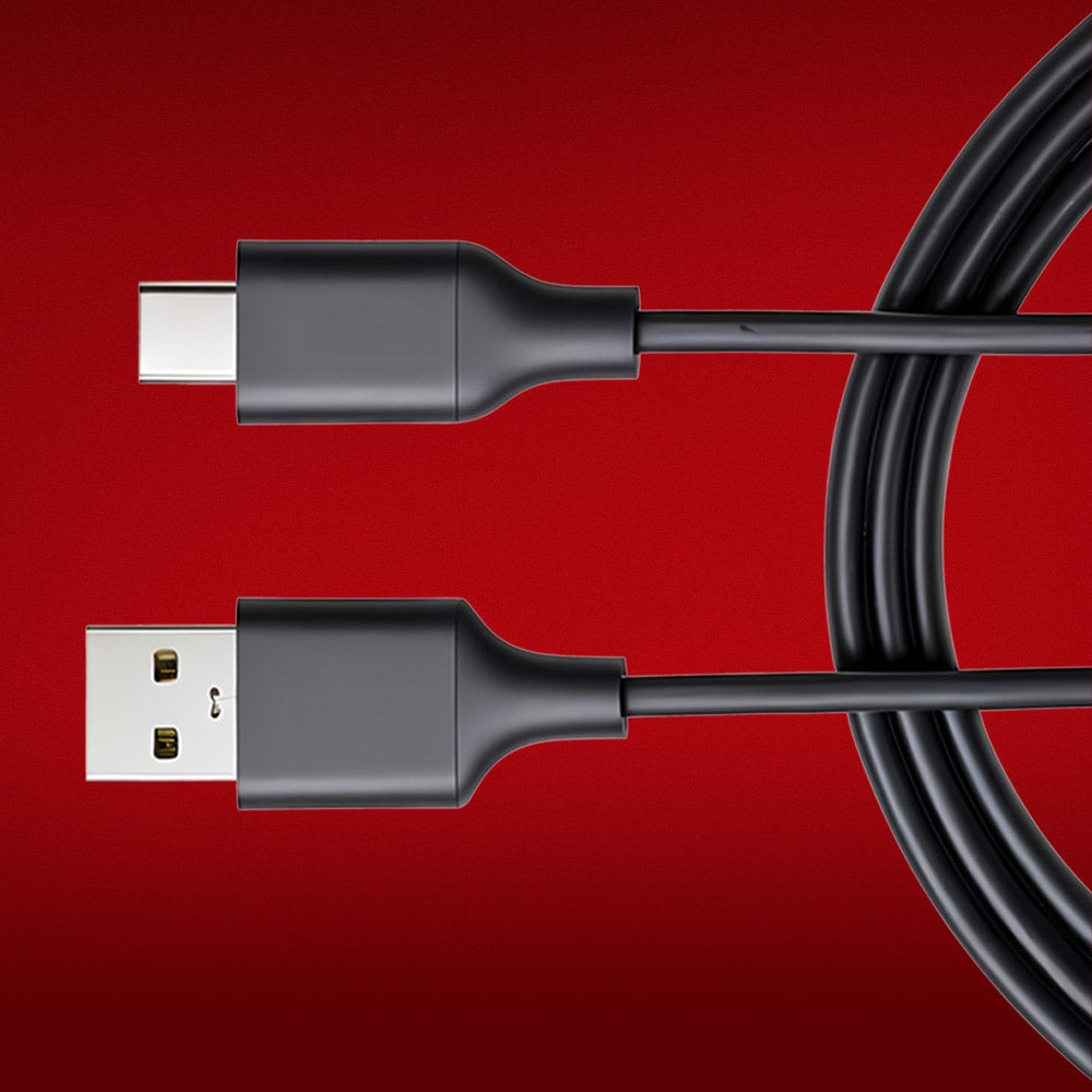 A black USB-A to USB-C cable against a solid red background, showing both connectors and part of the coiled cable.